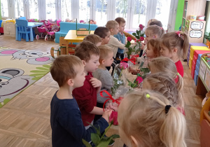 Chłopcy z Biedronek wręczają kwiaty swoim koleżankom